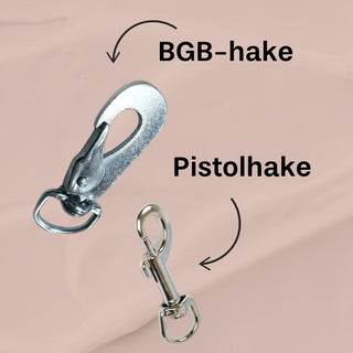 Hundinspiration Metizo koppel visar skillnaden mellan en robust BGB-hake och en smidig pistolhake i metall.